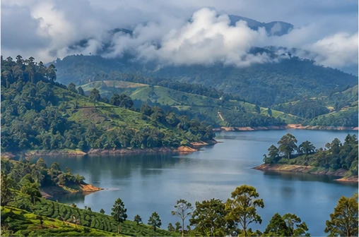 A reservoir in a highland valley surrounded by tea slopes